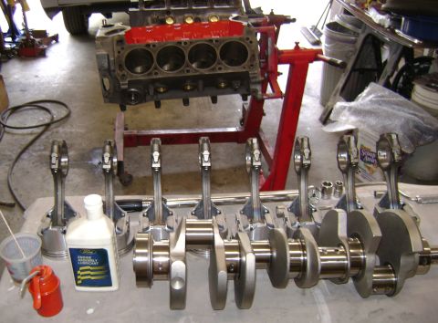 1972 Ford Ranchero - Engine components are laid out on a workbench, ready for assembly.