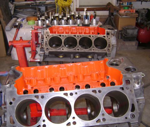 1972 Ford Ranchero - Two V8 engine blocks are shown, one painted orange and the other in bare metal, both mounted on engine stands.