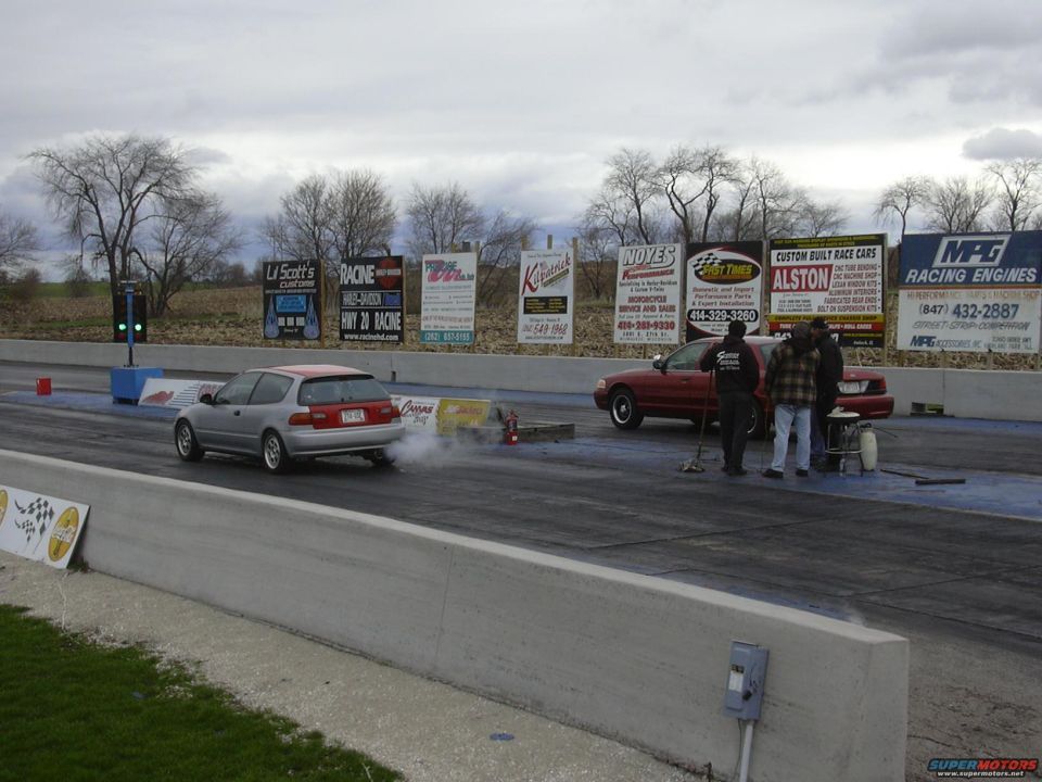 Red 1998 Ford Crown Victoria at drag strip