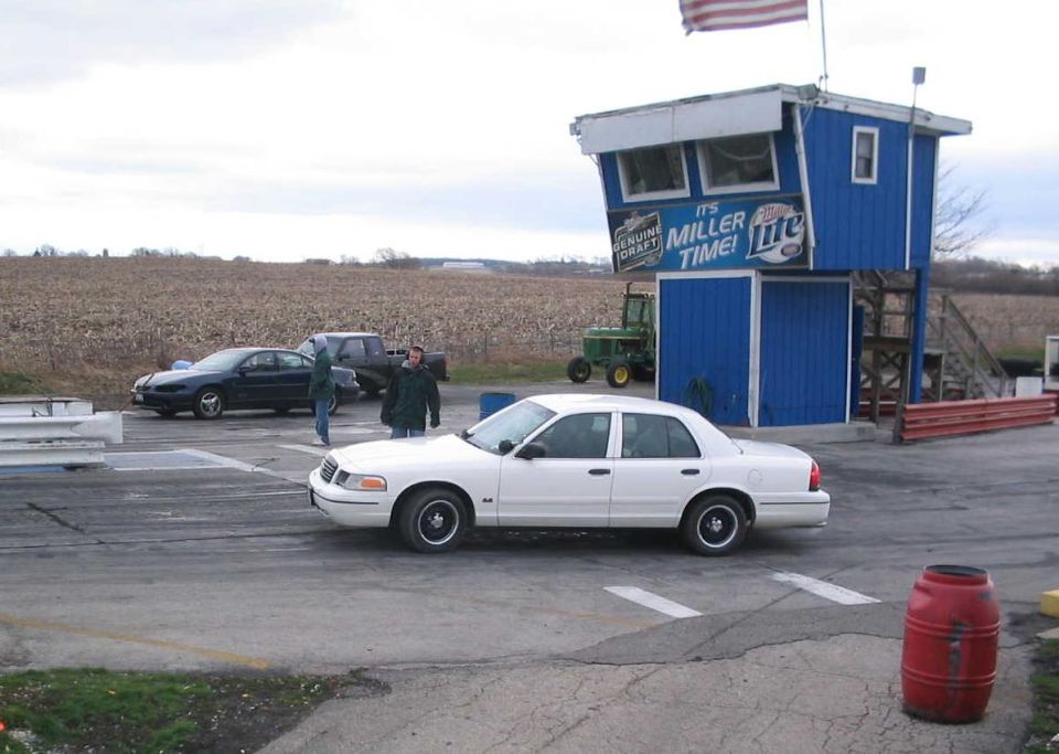 White 1998 Ford Crown Victoria sedan on a race track