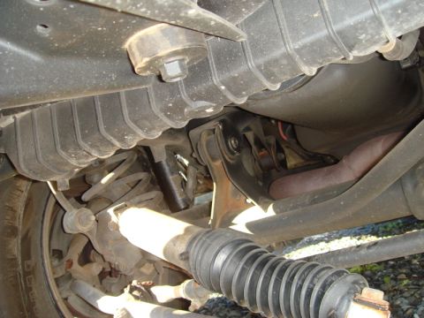 1996 Ford Bronco - Close-up view of the undercarriage, showing suspension components and exhaust piping.