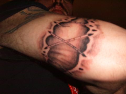 1993 Ford Bronco - Tattoo art depicting torn skin with crossed bones visible underneath.