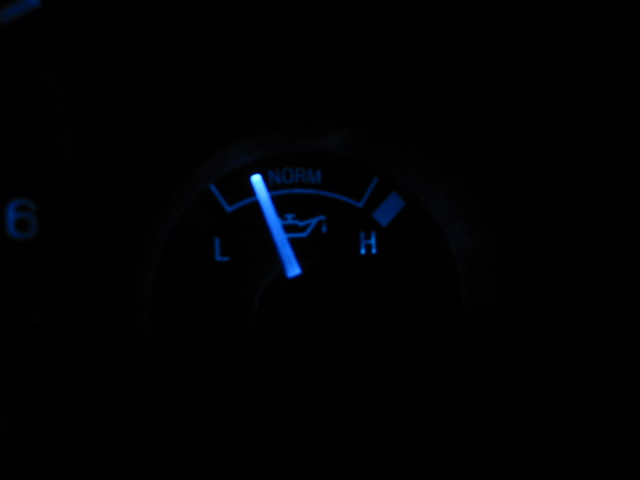 Blue oil pressure gauge with needle pointing to low