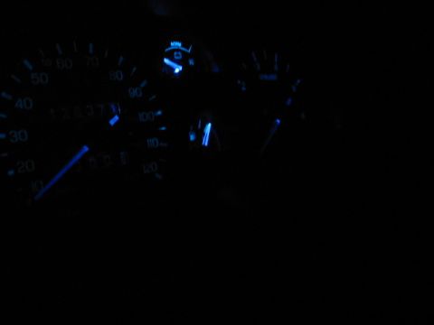 1995 Ford Thunderbird - Car dashboard gauges with blue backlighting, showing odometer reading 128371.