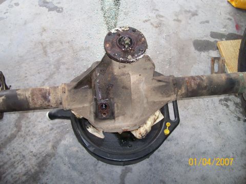 1996 Ford Bronco - Rear axle differential assembly shown with a drain pan, likely during maintenance or repair.