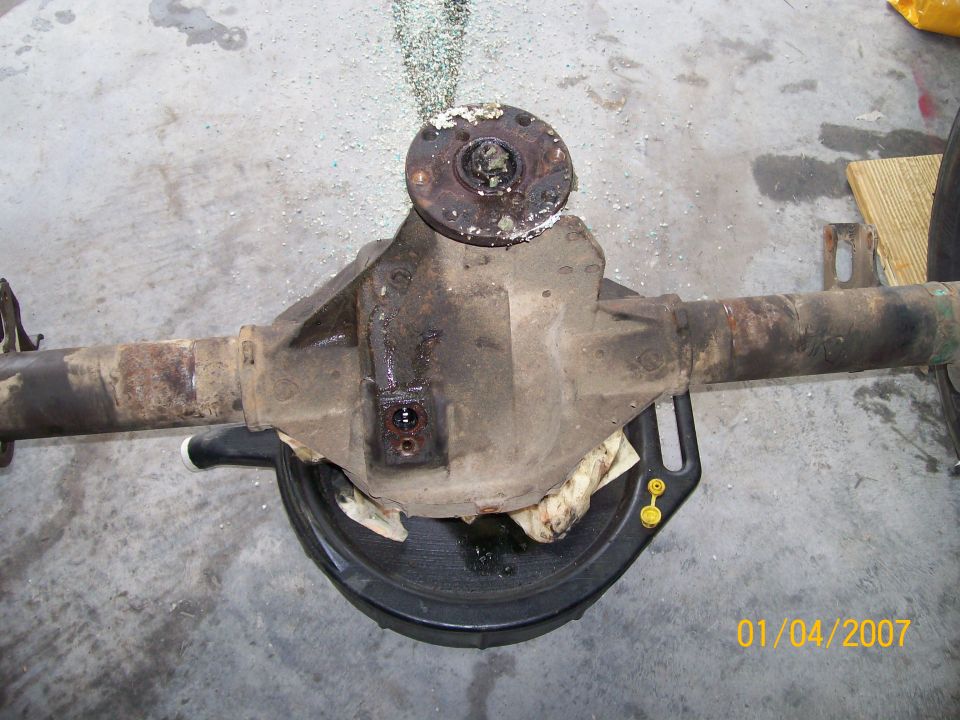 Rear axle differential assembly with a drain pan underneath. Date stamp reads 01/04/2007