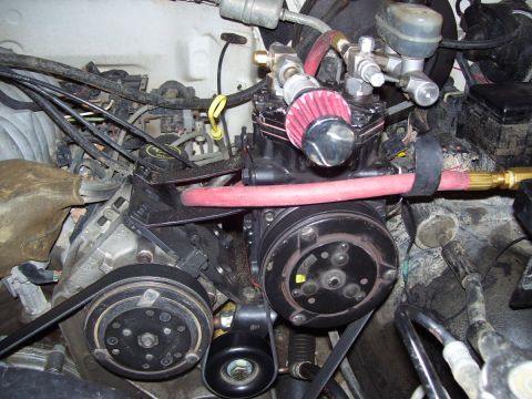 1992 Ford Bronco - Close-up view of the engine compartment, focusing on the air conditioning system components.