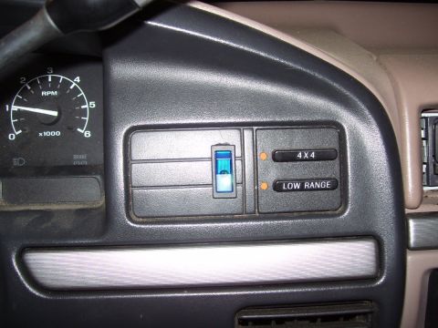 1992 Ford Bronco - Interior dashboard view showing the tachometer and 4x4 controls.