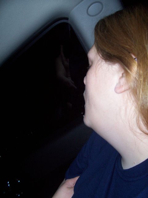 1989 Ford Bronco II - Woman looks out car window at night, reflection visible in the glass.
