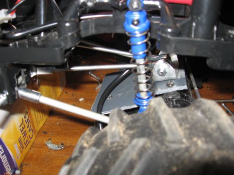 1990 Ford Bronco - The suspension system of a remote-controlled car is shown in detail, with a focus on the shock absorber and tire tread.