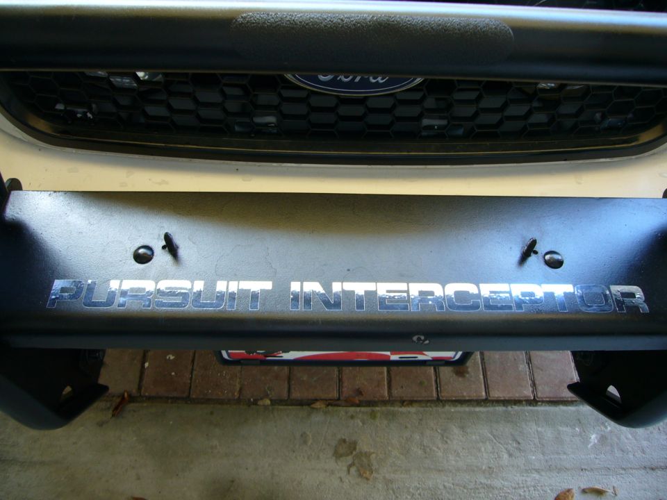 Push bumper with 'PURSUIT INTERCEPTOR' text. Ford grille visible above