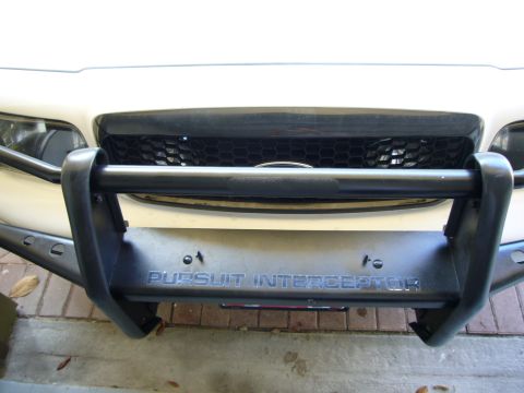 2000 Ford Crown Victoria - Front view of a 2000 Ford Crown Victoria's push bumper, which has "PURSUIT INTERCEPTOR" text.