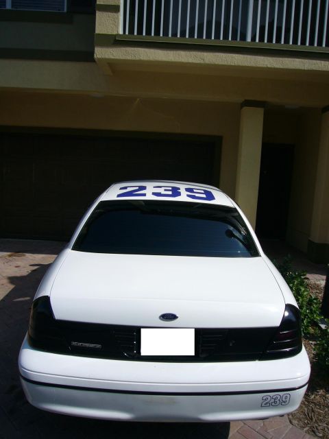 2000 Ford Crown Victoria - White 2000 Ford Crown Victoria displays unit number 239 on the roof and rear bumper.