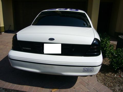2000 Ford Crown Victoria - White sedan with blue numbers '239' visible on the rear bumper and above the rear window.