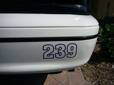 2000 Ford Crown Victoria - Close-up of a white rear bumper with the number 239 in blue.