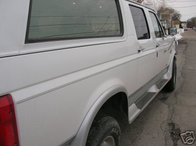 1995 Ford C-350 (Centurion Conversions) - Side view of a white 1995 Ford C-350 (Centurion Conversions) showing its body lines and trim.