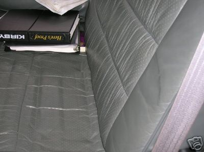 1995 Ford C-350 (Centurion Conversions) - Interior view of vehicle seats with binders and papers stacked on the seat.