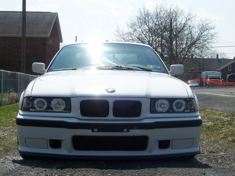 2001 BMW 3 Series - The front of a white BMW sedan is shown parked outdoors on a sunny day.
