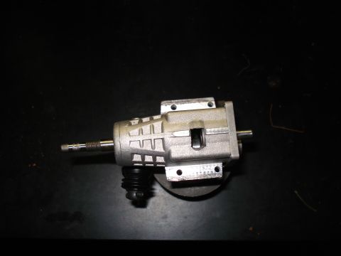 1994 Ford Bronco - A close-up view of a metal steering gearbox with a black rubber boot.