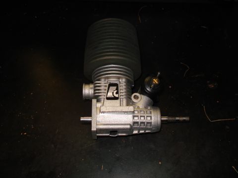 1994 Ford Bronco - Model airplane engine with black air filter on a dark surface.