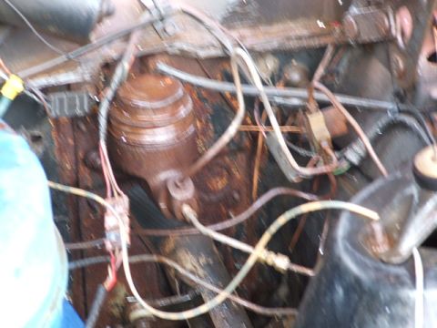 1966 Ford Ranchero - Close-up of corroded engine bay components, including a brake master cylinder and various wires.