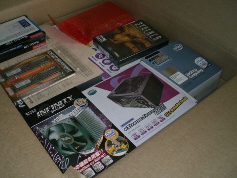 1995 Ford Probe - A collection of computer components, such as RAM modules, a CPU cooler, and a power supply unit, are organized within a cardboard box.