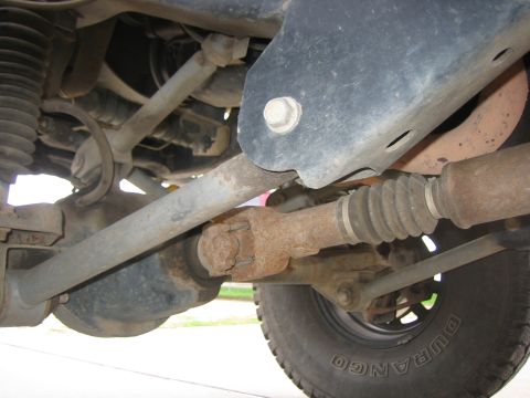 2001 Jeep Wrangler - Undercarriage view of a vehicle, focusing on suspension and drivetrain parts.