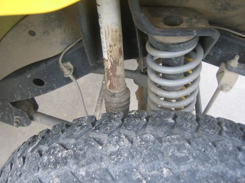 2001 Jeep Wrangler - Close-up of the front suspension and tire on a 2001 Jeep Wrangler.