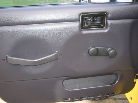2001 Jeep Wrangler - Interior view of a 2001 Jeep Wrangler door panel, showing the manual window crank and lock mechanism.