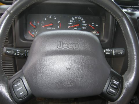 2001 Jeep Wrangler - Interior view of a Jeep Wrangler, showing the steering wheel, dashboard, and instrument cluster.