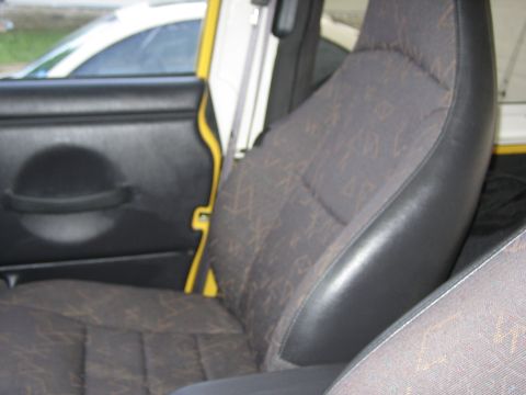 2001 Jeep Wrangler - Interior view of a 2001 Jeep Wrangler, highlighting the patterned seats and door panel details.