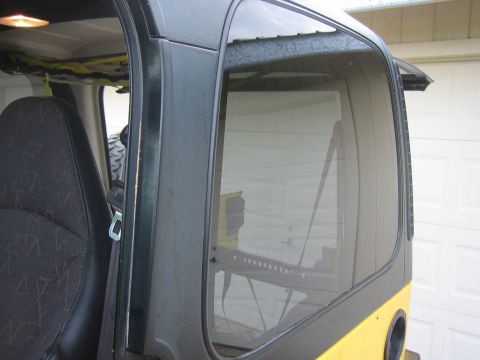 2001 Jeep Wrangler - Interior view of a 2001 Jeep Wrangler, showing the patterned seat and side window with reflections.