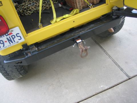 2001 Jeep Wrangler - Rear view of a yellow Jeep Wrangler showing the bumper, tow hitch, and license plate.