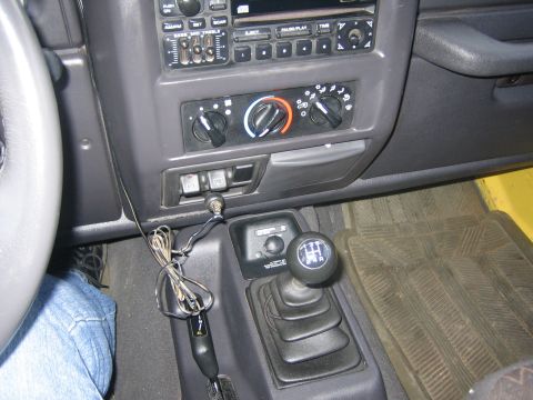 2001 Jeep Wrangler - The interior of a 2001 Jeep Wrangler, the center console, gear shift, and radio controls.