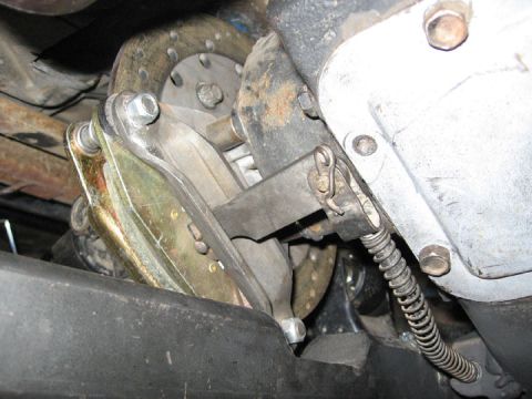 1994 Ford Bronco - Close-up view of a vehicle's parking brake mechanism, showing the coiled spring and brake disc.