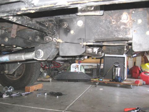 1994 Ford Bronco - Underside view of a vehicle's e-brake system and suspension parts.