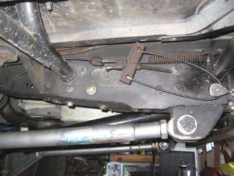 1994 Ford Bronco - Close-up of the parking brake cable mechanism, showing the spring and linkage system.