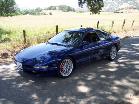 1995 Ford Probe - A blue 1995 Ford Probe is parked outdoors on a sunny day.