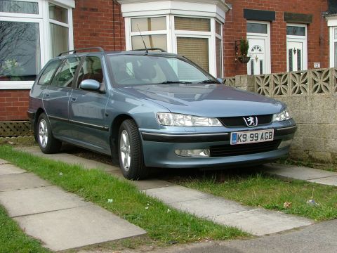 2001 Peugeot 406 - A blue 2001 Peugeot 406 station wagon is parked in a driveway in front of a brick house.