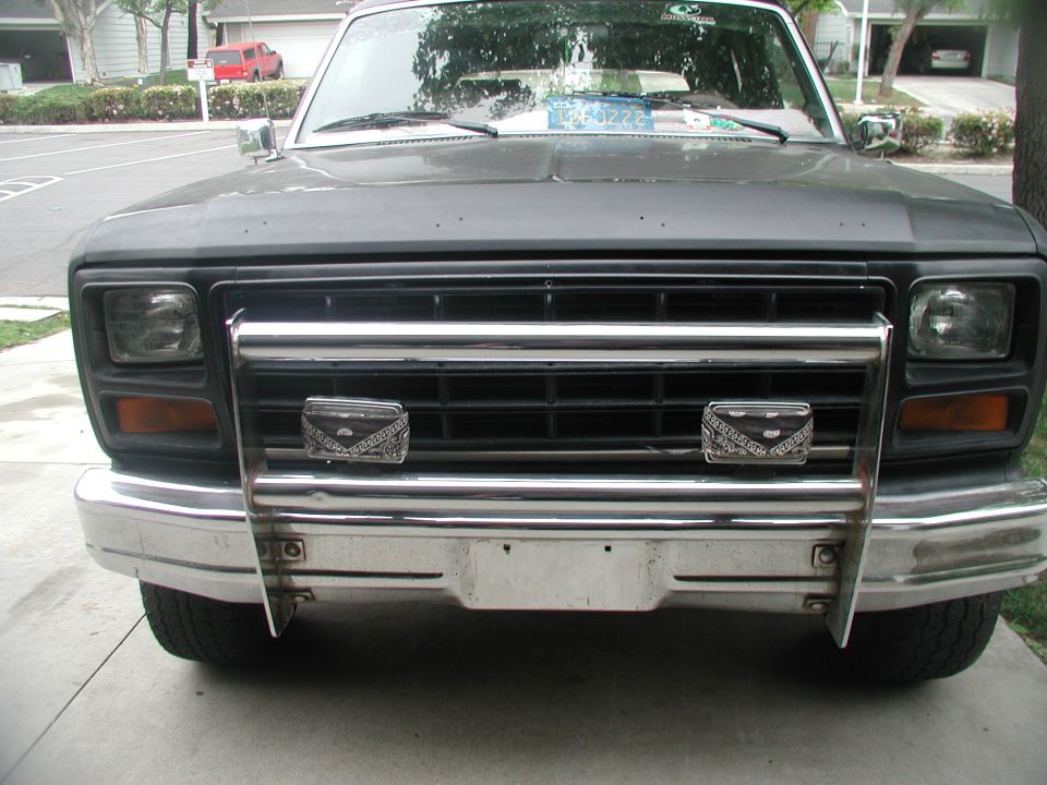 Gray Ford Bronco front end with chrome grille guard and two decorative bandana-patterned lights