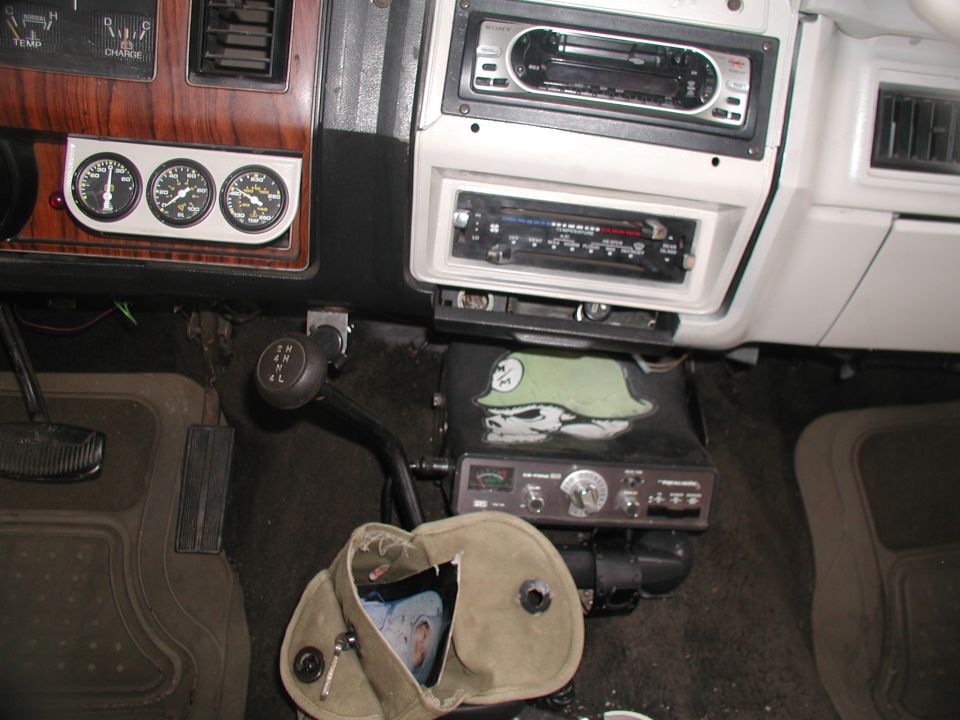 Interior dashboard with gauges, CB radio, and aftermarket stereo