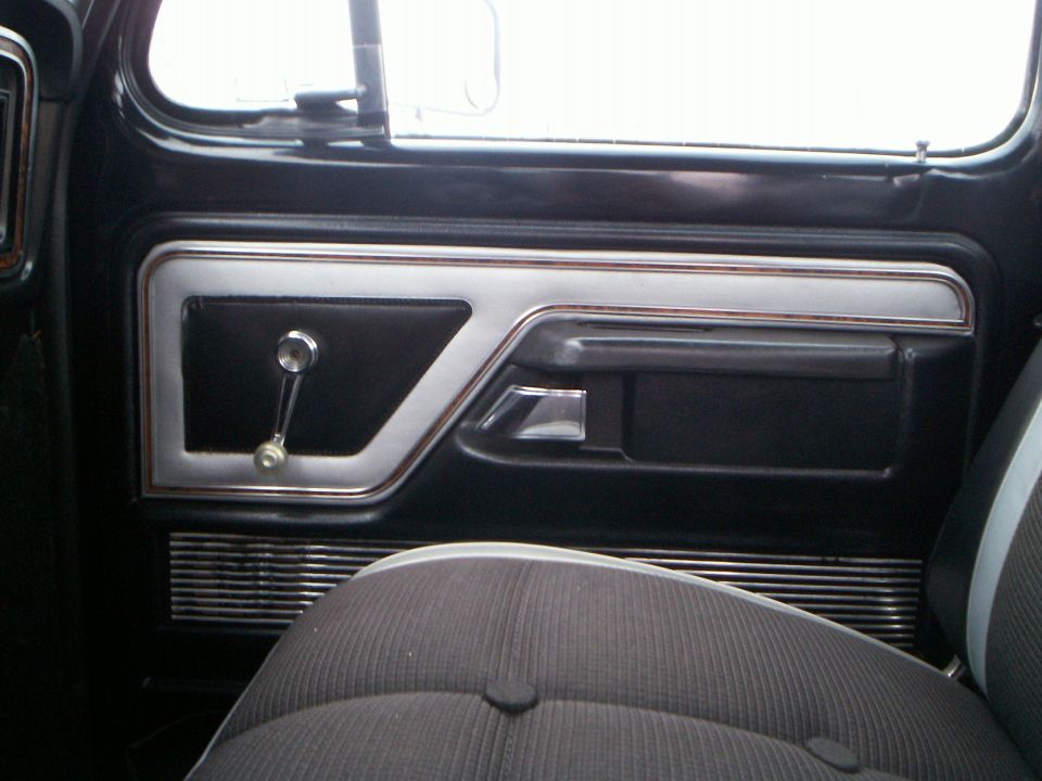 1979 Ford F-250 interior door panel with chrome accents and manual window crank