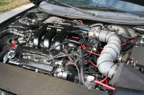 1995 Ford Probe - Close-up view of a modified engine bay, a Mazda engine and custom intake.