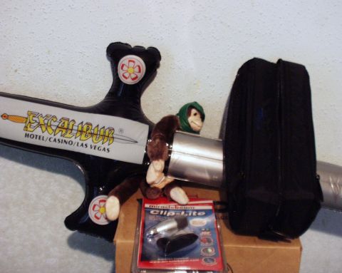2000 Ford Crown Victoria - A plush monkey sits atop an inflatable Excalibur sword, with a package of automotive lights nearby.