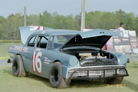 1976 Ford Ranchero - This race car, identified by its 1956 Ford body style, has its hood and trunk open, displaying the number 16 on its side.