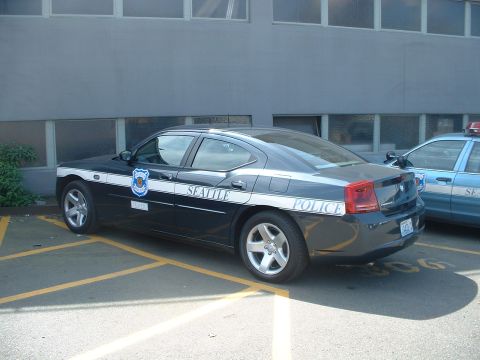 2000 Ford Crown Victoria - Seattle Police car parked in a lot, with another police vehicle visible to the right.