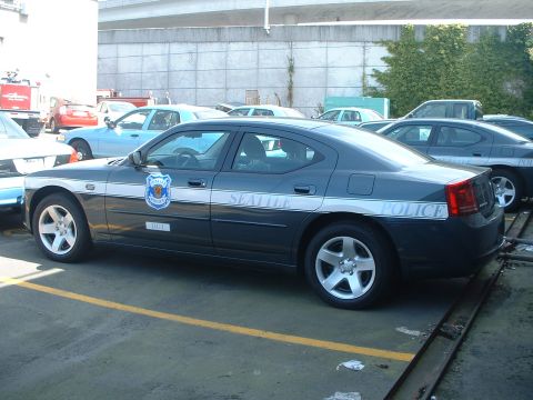 2000 Ford Crown Victoria - A Seattle Police car is parked in a lot with other vehicles.