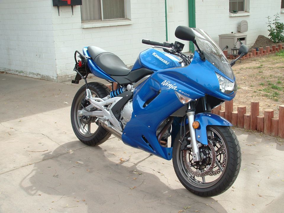 Blue Kawasaki Ninja 650R from front three-quarter on a concrete driveway