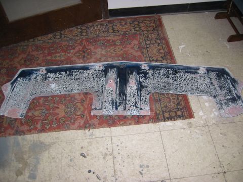 1996 Ford Bronco - A car bumper is shown indoors, resting on a rug and a tiled floor.