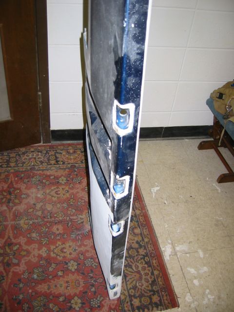1996 Ford Bronco - A blue car door, partially primed, is shown from the side with visible mounting points.